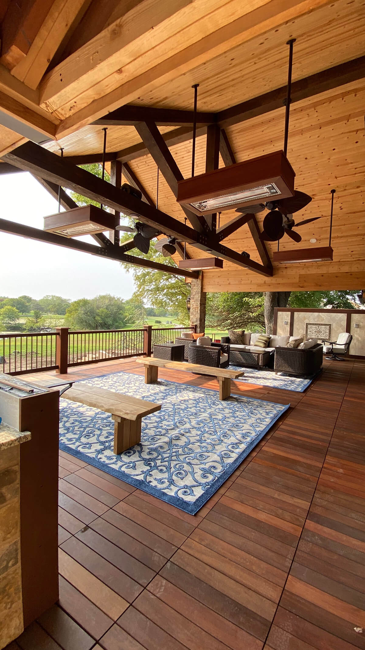 Wooden Deck with two seating areas, overhead fans and heating lamps.